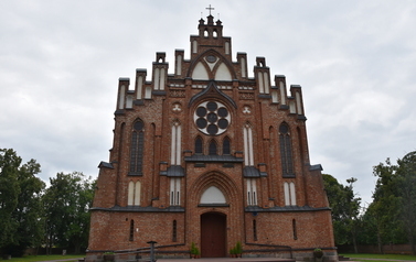 widok na fasadę kościoła parafialnego w Kamionnie na tle pochmurnego nieba